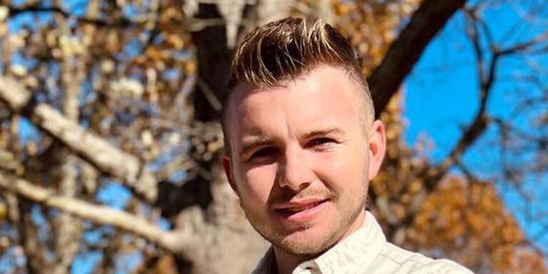 james duggar 19 kids and counting smiling in front of a tree