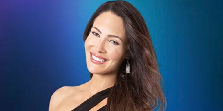 Meisha 90 Day Fiancé wearing black top smiling against dark blue background