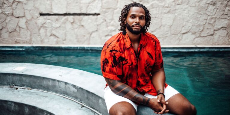 Brenden Durell from Too Hot To Handle, sitting on the edge of a pool