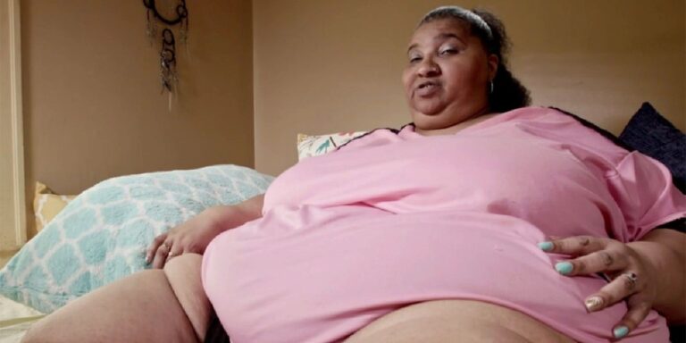 Renee Biran from my 600-lb life in a pink top in bed with her legs showing